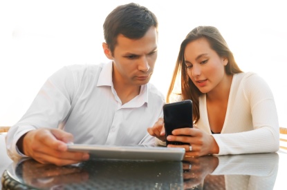 Paar mit Tablet und Smartphone